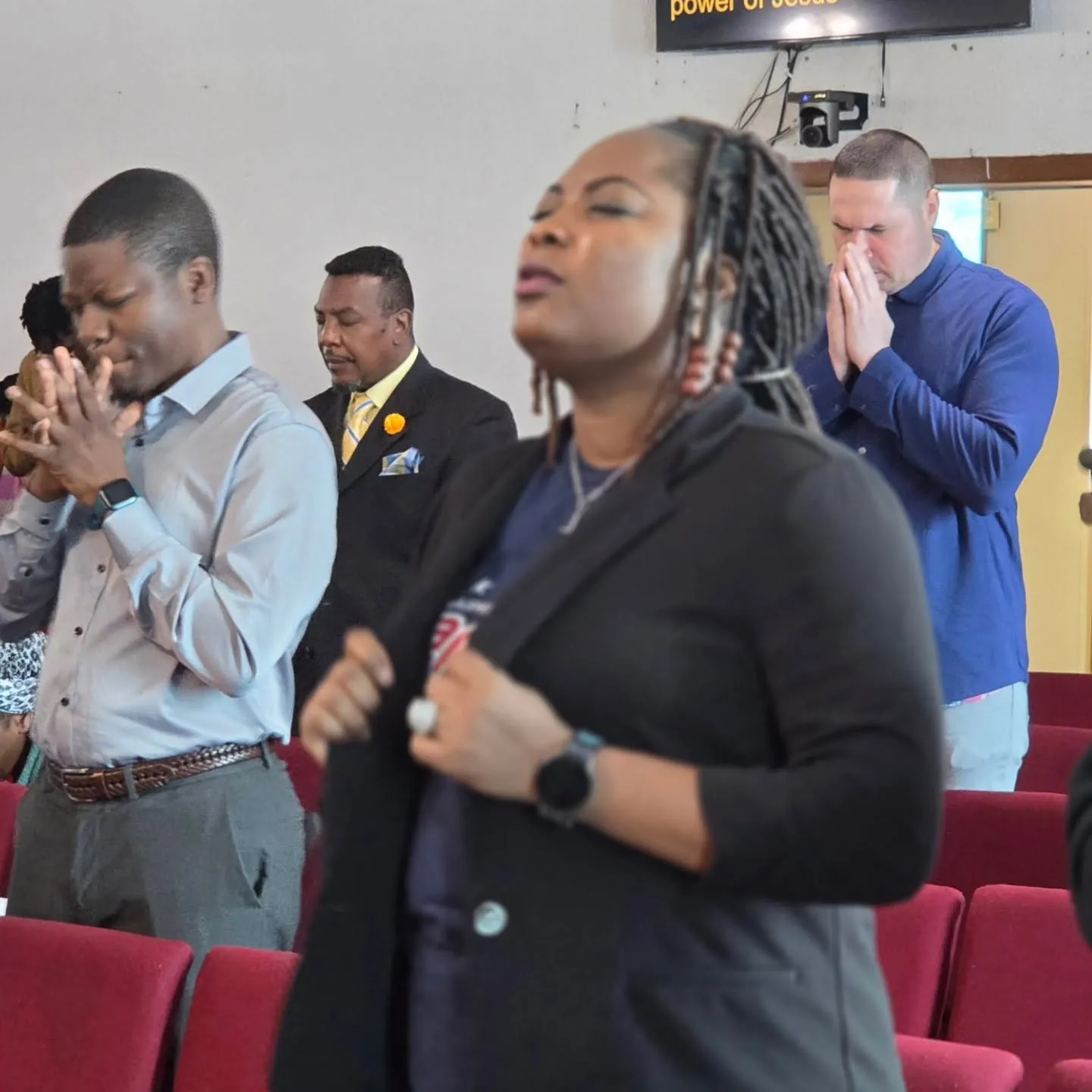 Victory House members praying together