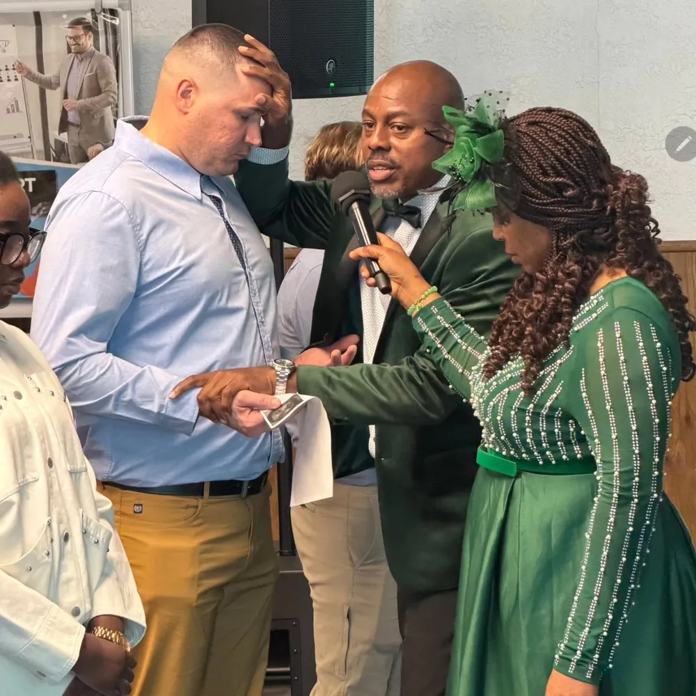 Victory House members praying together