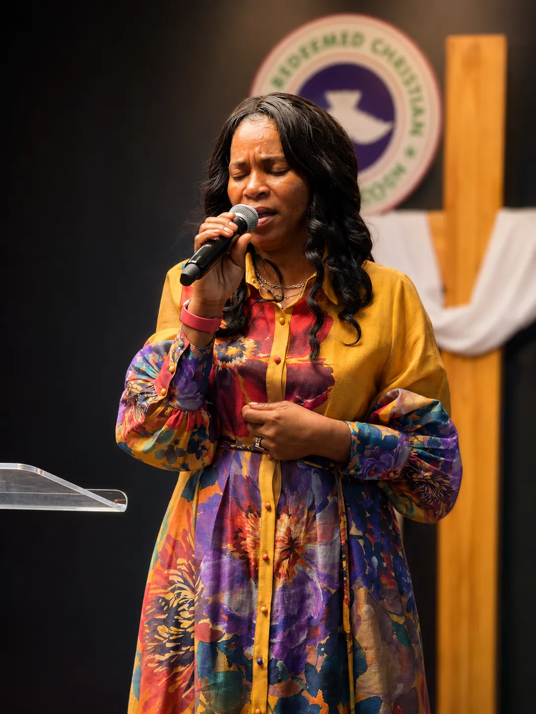 A Victory House member singing during worship
